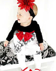 Infant baby girl wearing a pair of Mary Jane shoe design tights for Christmas photo
