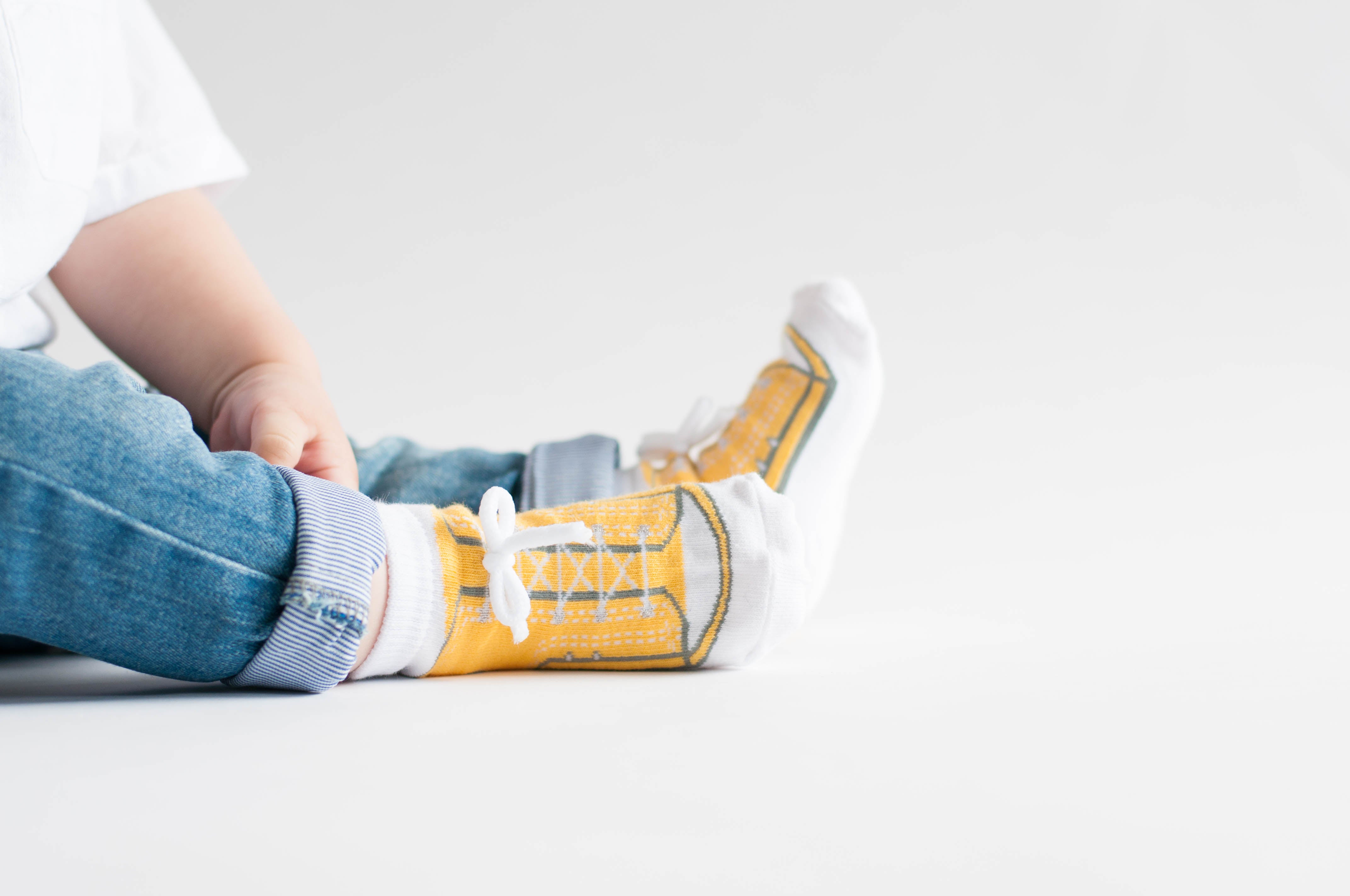Yellow baby boy sneaker socks that look like shoes with faux shoelaces
