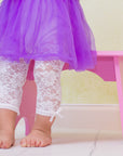 Toddler girl wears lacy leggings cream color off white