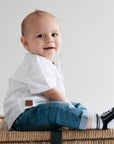 Little boy wearing navy blue socks with shoelaces and non-slip soles