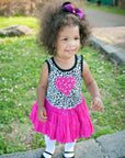 Little girl in hot pink dress with Mary Jane shoe look tights