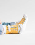 Yellow baby boy sneaker socks that look like shoes with faux shoelaces
