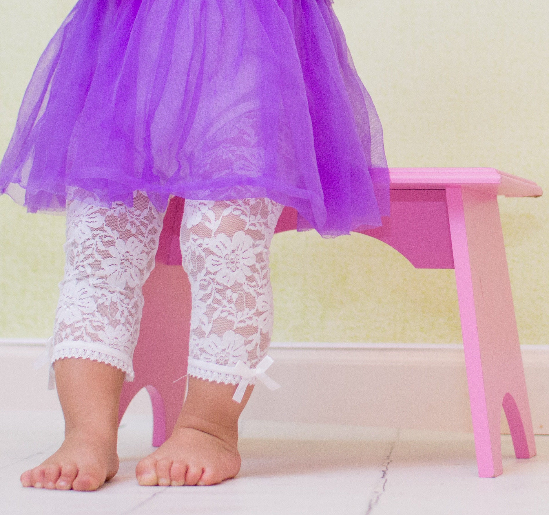 Toddler girl wears lacy leggings cream color off white