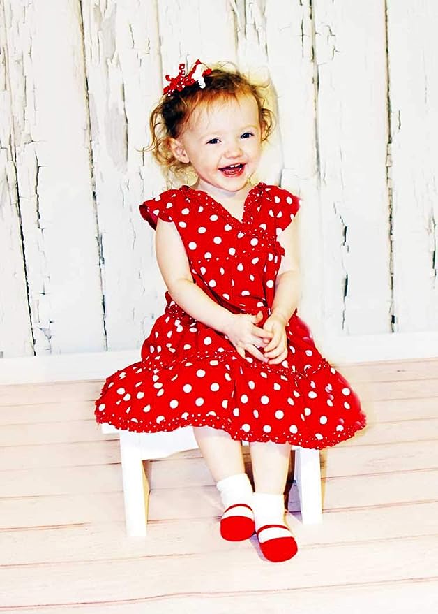 Baby girl model wearing red dress with red socks with shoe-look