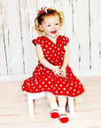Baby girl model wearing red dress with red socks with shoe-look