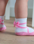 Pink ballerina baby girl socks 0-12 months with satin bows and non-slip grippers