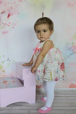 Baby girl wearing white tights with pink shoe design