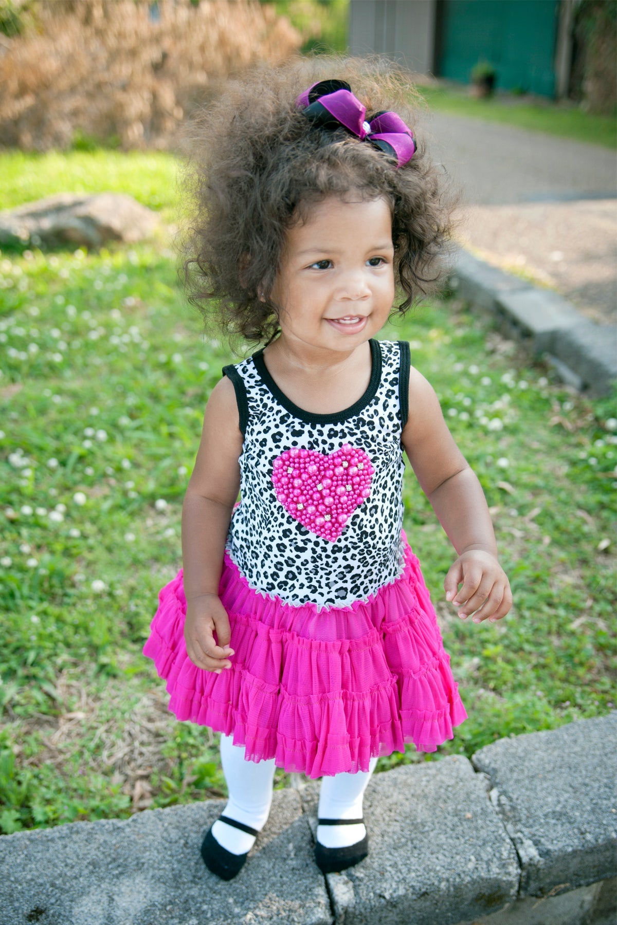 Little girl in hot pink dress with Mary Jane shoe look tights